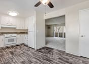 Thumbnail 33 of 51 - A kitchen with white cabinets and a ceiling fan.