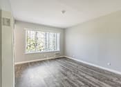 Thumbnail 24 of 42 - A room with a window and a wooden floor.