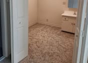 Thumbnail 16 of 42 - A white door is open to a room with a carpeted floor.