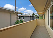 Thumbnail 8 of 16 - A balcony with a grey building in the background.