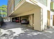 Thumbnail 13 of 36 - a parking garage with a car parked in it