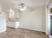 Thumbnail 24 of 37 - A kitchen with white cabinets and a white refrigerator.