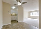 Thumbnail 21 of 33 - an empty living room and kitchen with a ceiling fan