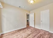 Thumbnail 2 of 21 - A room with a light brown floor and white walls.