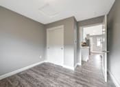 Thumbnail 48 of 62 - A room with a white door and a grey floor.