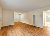 Thumbnail 27 of 43 - A room with wooden floors and white walls.