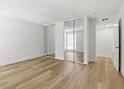 Thumbnail 49 of 92 - A room with wooden floors and white walls.