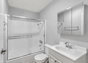 Thumbnail 40 of 40 - A white bathroom with a toilet, sink, and shower.
