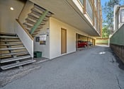 Thumbnail 12 of 36 - the entrance to an apartment building with stairs and a car parked