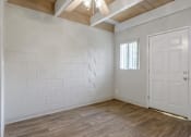 Thumbnail 24 of 32 - A room with a white door and a window with blinds.