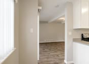 Thumbnail 15 of 27 - A kitchen area with a stove top oven and white cabinets.