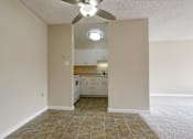 Thumbnail 14 of 33 - an empty living room and kitchen with a ceiling fan