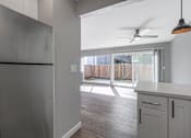 Thumbnail 33 of 53 - a kitchen with a refrigerator and a ceiling fan