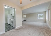 Thumbnail 9 of 29 - A kitchen with a refrigerator, oven, and stove is visible through a glass door.