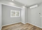 Thumbnail 51 of 67 - A room with wooden flooring and a window with blinds.