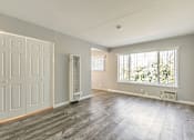 Thumbnail 34 of 42 - A room with a grey floor and a window with blinds.