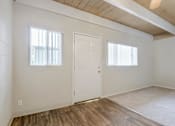 Thumbnail 25 of 32 - A room with a white door and a window with white blinds.