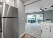 Thumbnail 25 of 53 - a kitchen with a stainless steel refrigerator and a window