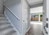 Thumbnail 32 of 53 - a white door leading to a staircase in a house