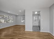 Thumbnail 9 of 31 - A room with wooden floors and white walls.
