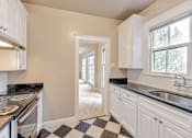 Thumbnail 36 of 42 - A kitchen with black and white checkered floor.