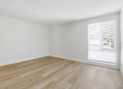 Thumbnail 55 of 92 - A room with wooden flooring and a window with blinds.