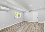 Thumbnail 53 of 60 - A room with a white door and a window with blinds.