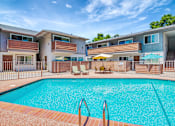 Thumbnail 25 of 25 - A swimming pool in front of apartment buildings.