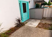 Thumbnail 17 of 25 - a sidewalk in front of a house with a green door