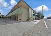 Thumbnail 14 of 16 - A building with a green awning is shown in the image.