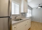 Thumbnail 14 of 29 - a kitchen with a sink and a refrigerator