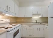 Thumbnail 12 of 33 - a kitchen with white appliances and white cabinets