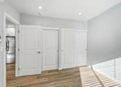 Thumbnail 67 of 67 - Three white doors are in a room with wooden floors.