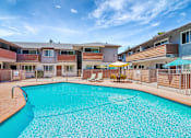 Thumbnail 18 of 25 - A swimming pool in front of apartment buildings.