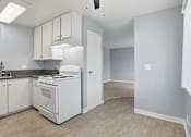 Thumbnail 54 of 55 - A kitchen with white appliances and cabinets.