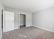 Thumbnail 17 of 33 - A room with a carpeted floor and two open doors.