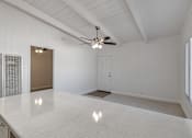 Thumbnail 39 of 44 - A spacious room with a ceiling fan and a large table.
