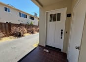 Thumbnail 11 of 19 - the entrance to a home with a white door and a driveway