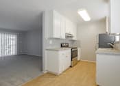 Thumbnail 13 of 29 - a kitchen with white cabinets and a stove and a refrigerator