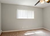 Thumbnail 21 of 27 - A room with a window and a ceiling fan.