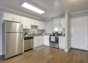 Thumbnail 12 of 35 - A kitchen with stainless steel appliances and white cabinets.