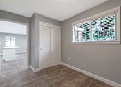 Thumbnail 47 of 62 - A room with a window covered in blinds and a white door.