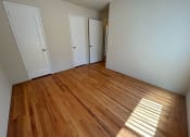 Thumbnail 10 of 19 - a living room with wood floors and white walls