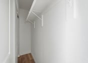 Thumbnail 60 of 67 - A white room with a wooden floor and white walls.