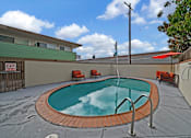 Thumbnail 11 of 16 - A small pool with a red tile border and a metal ladder.