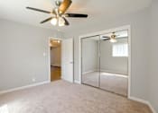 Thumbnail 20 of 27 - A room with a ceiling fan and a sliding glass door.