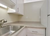 Thumbnail 10 of 33 - a kitchen with a sink and a refrigerator