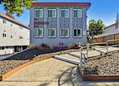 Thumbnail 29 of 29 - a building with a playground in front of it