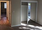 Thumbnail 22 of 42 - A room with a carpeted floor and a white door.