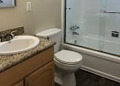 Thumbnail 17 of 22 - A bathroom with a toilet, sink, and shower.